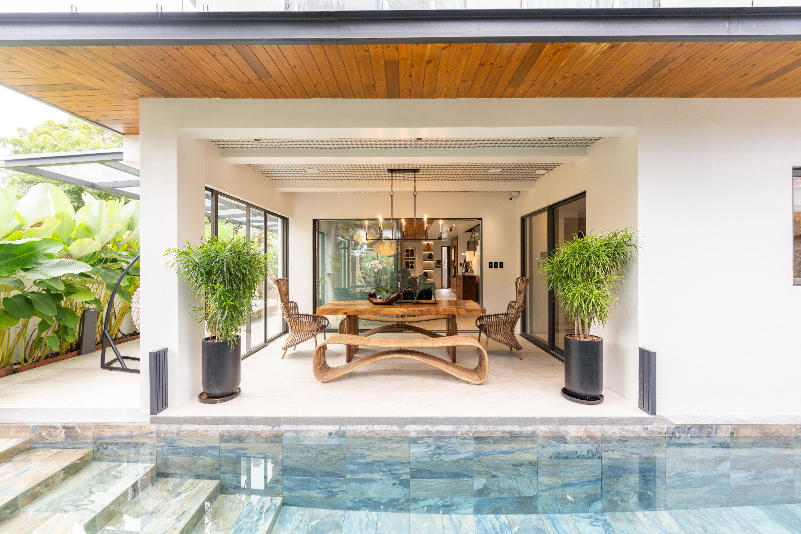 The pool area and deck area of Pia Wurtzbach Jauncey's home seamlessly blending in hues of neutrals, greens and blues