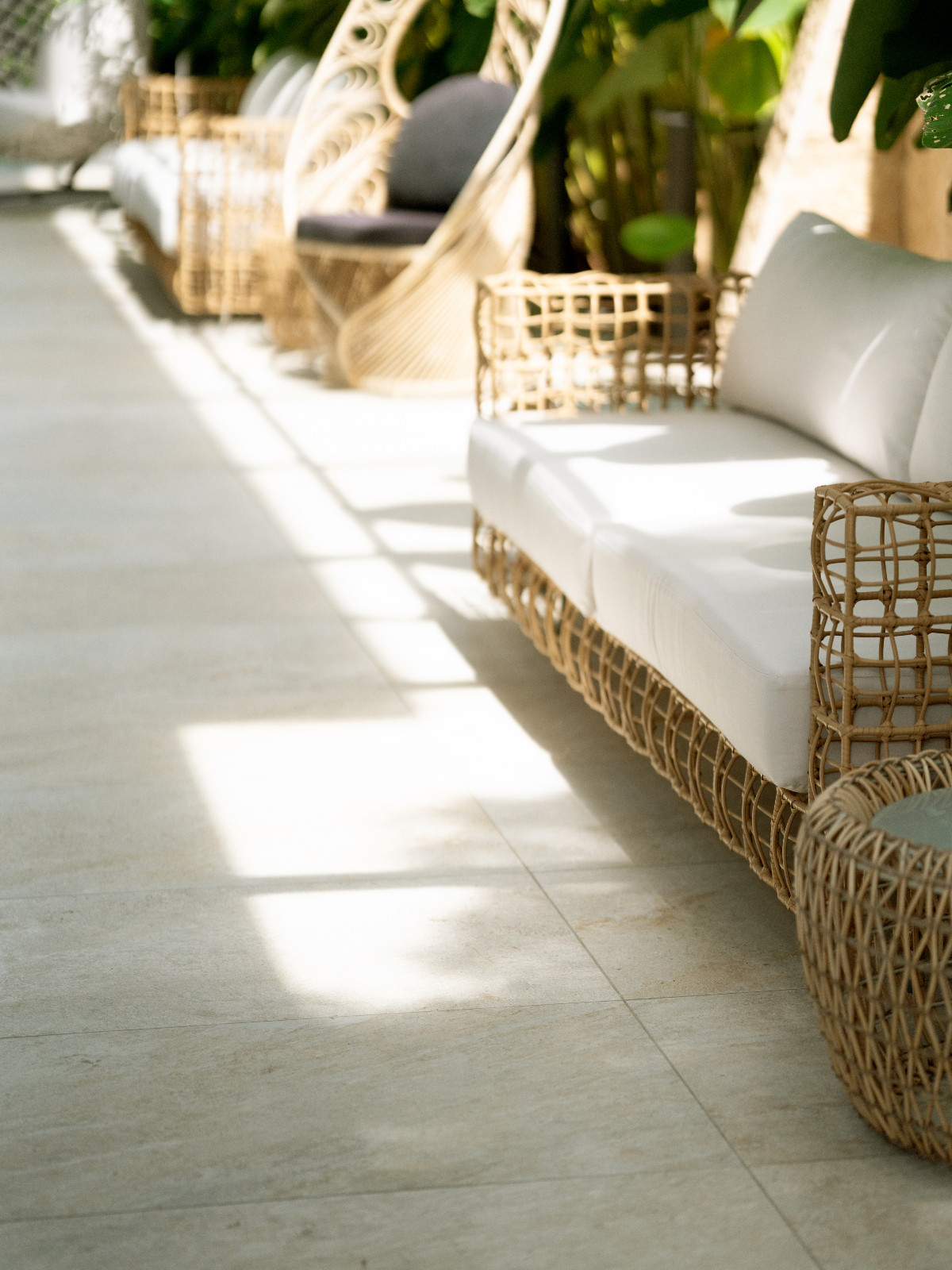 The perimeter deck of Pia Wurtzbach Jauncey's home utilises the same Atlas Concorde tiles by The Tile Gallery, and the lightness of their shade is echoed in the Kenneth Cobonpue seating in the area