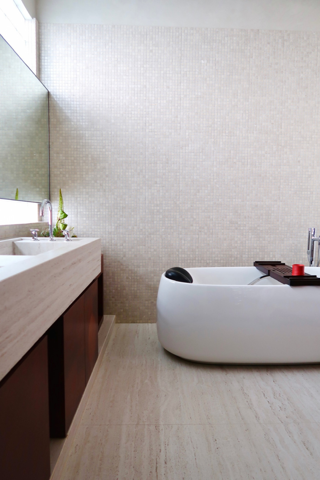 The Dekton Marmorio contrasts beautifully with the mosaic-tiled wall, and the veneer of the vanity cabinet