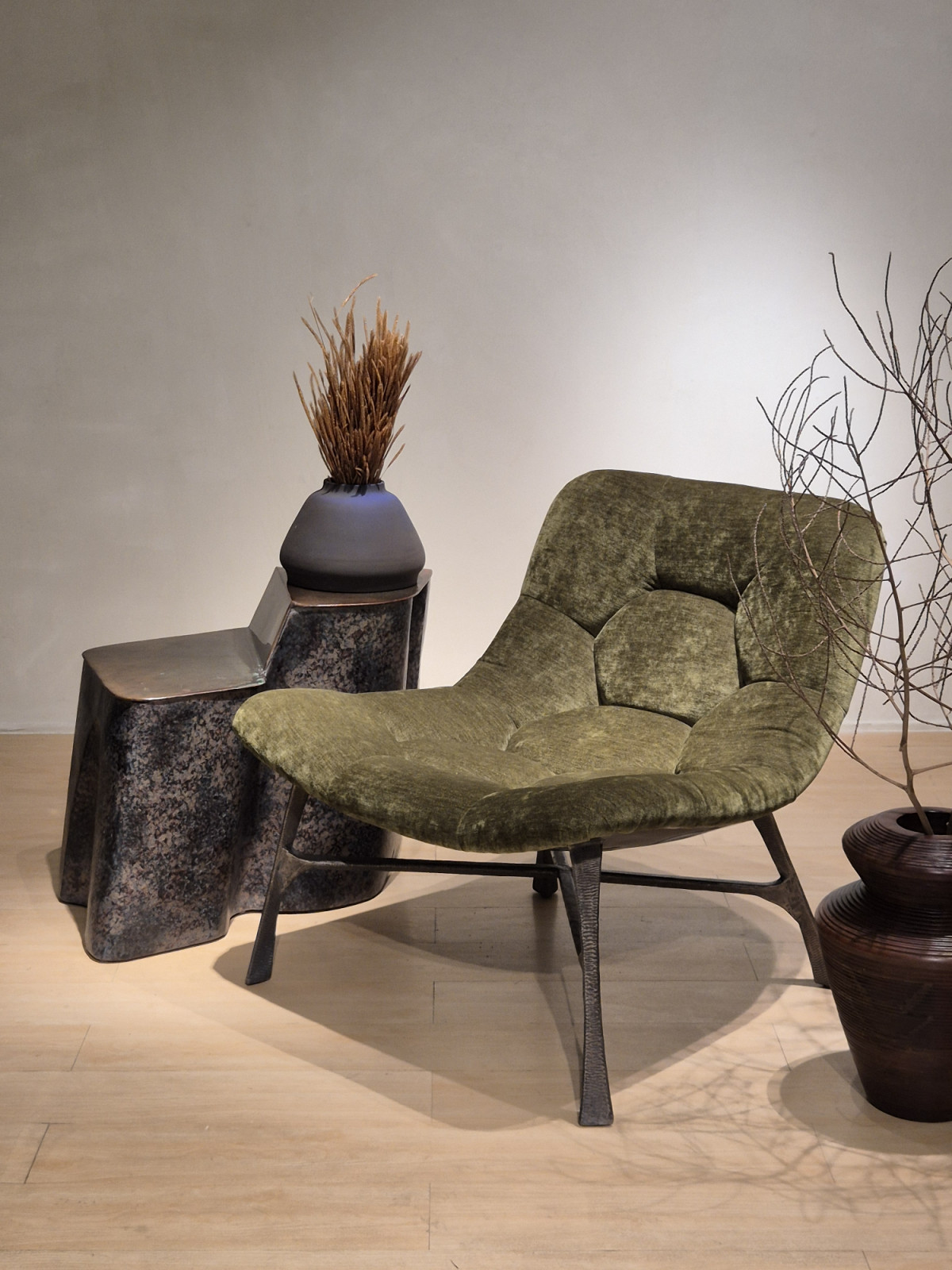 Front view of the Bordeaux Chair showing the curved seat form and distinctive metal base structure