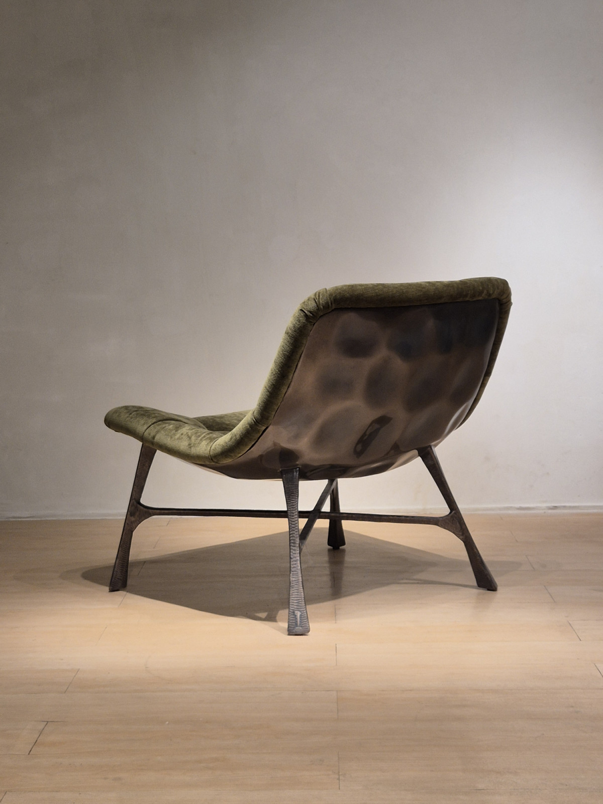 Rear view of the Bordeaux Chair revealing the hammered metal backing beneath the upholstered seat