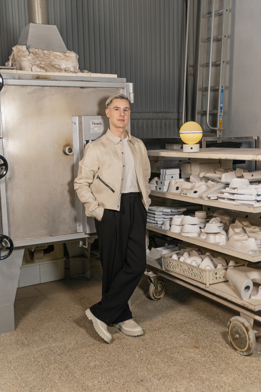 British designer Lee Broom at the Lladró porcelain workshop in Spain with the Cascade Wireless Lamp