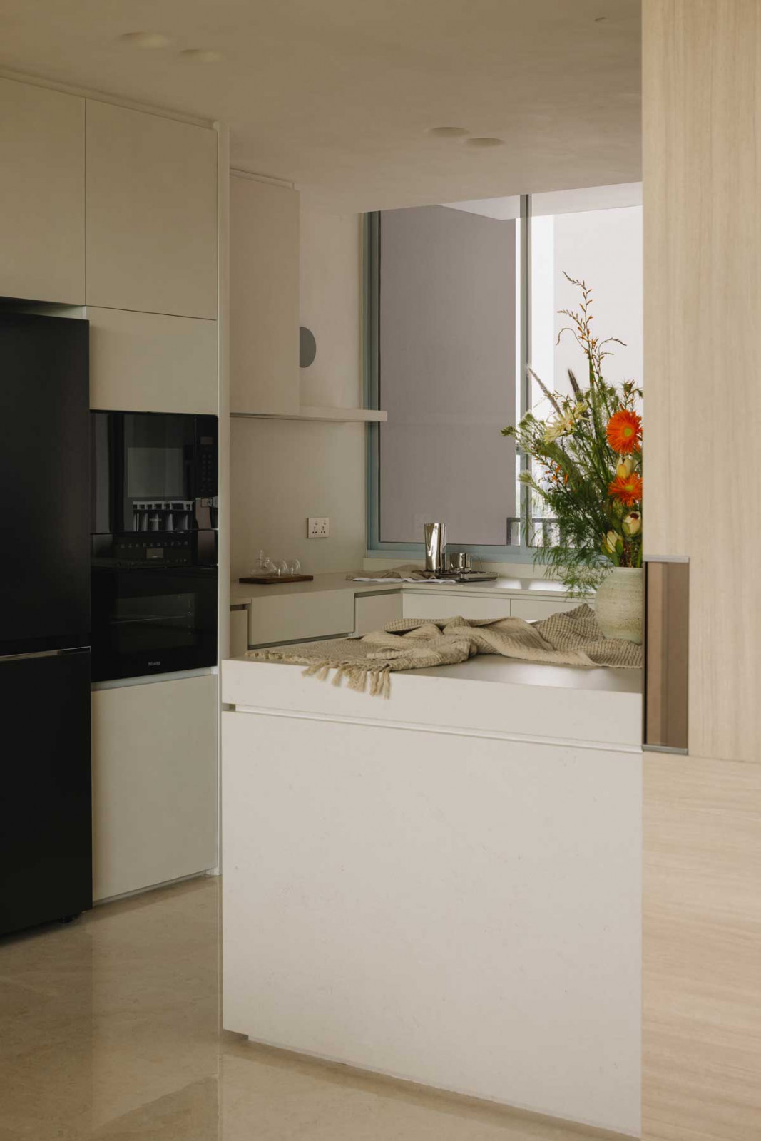Soft lighting sets the tone in the East Coast apartment’s cosy kitchen