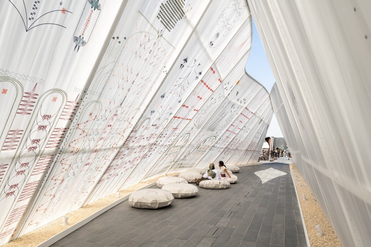 Interior of Maraj’s “Stories of the Isle and the Inlet” pavilion, comprising layered translucent mesh textiles embroidered with Nabih Saleh’s island flora and fauna.