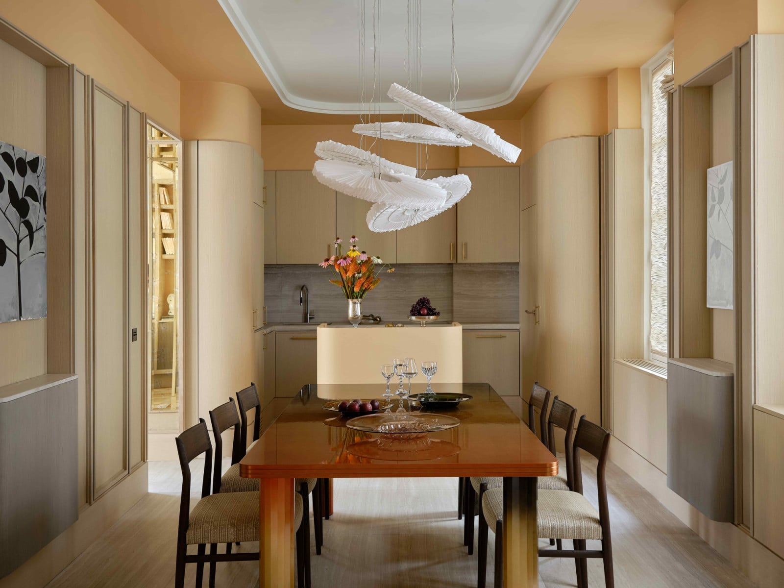 In the dining room, the “E-Collar” ceiling installation by Sam Stewart animates the space