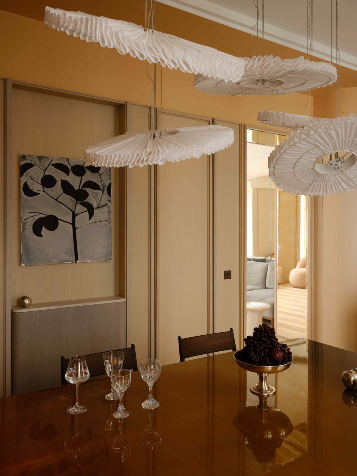 The high-gloss varnish of the dining table captures light and reflection