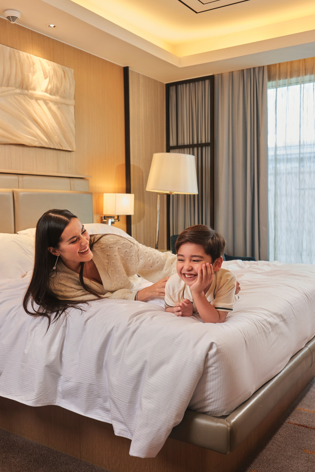 The family guide to exploring Newport World Resorts: this mom plays with his son in one of the resort's beautifuls suites