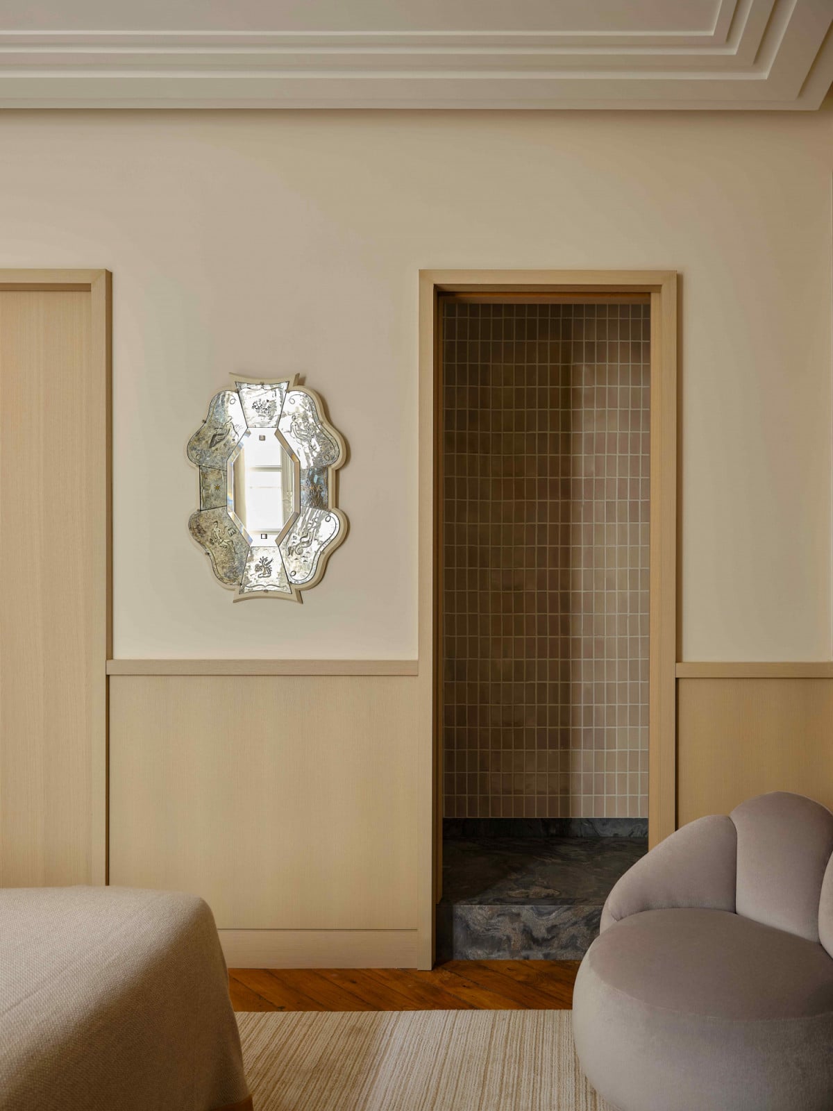 The 1940s engraved mirror by Pierre Lardin hangs in the bedroom