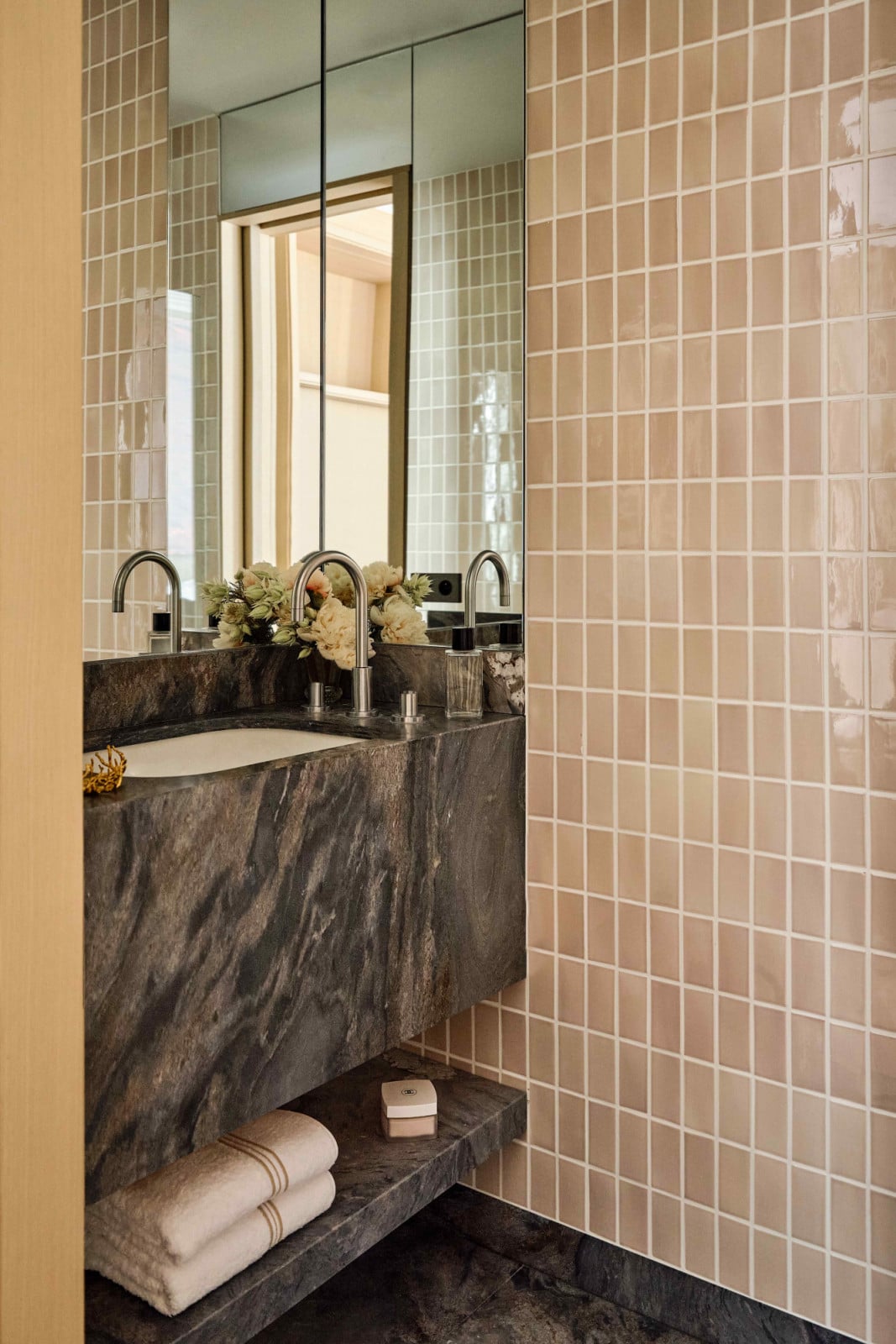 The adjoining water closet is tucked away behind the sliding door