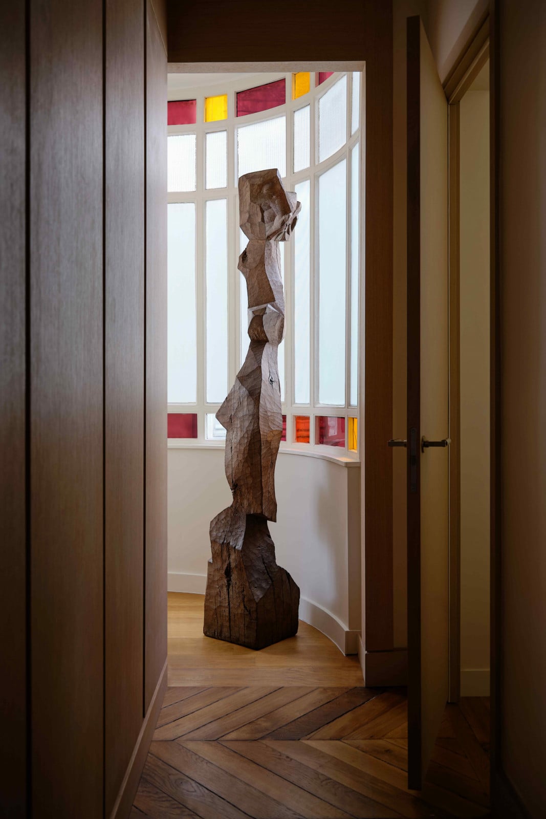 The towering Jean Touret sculpture framed by original window panels