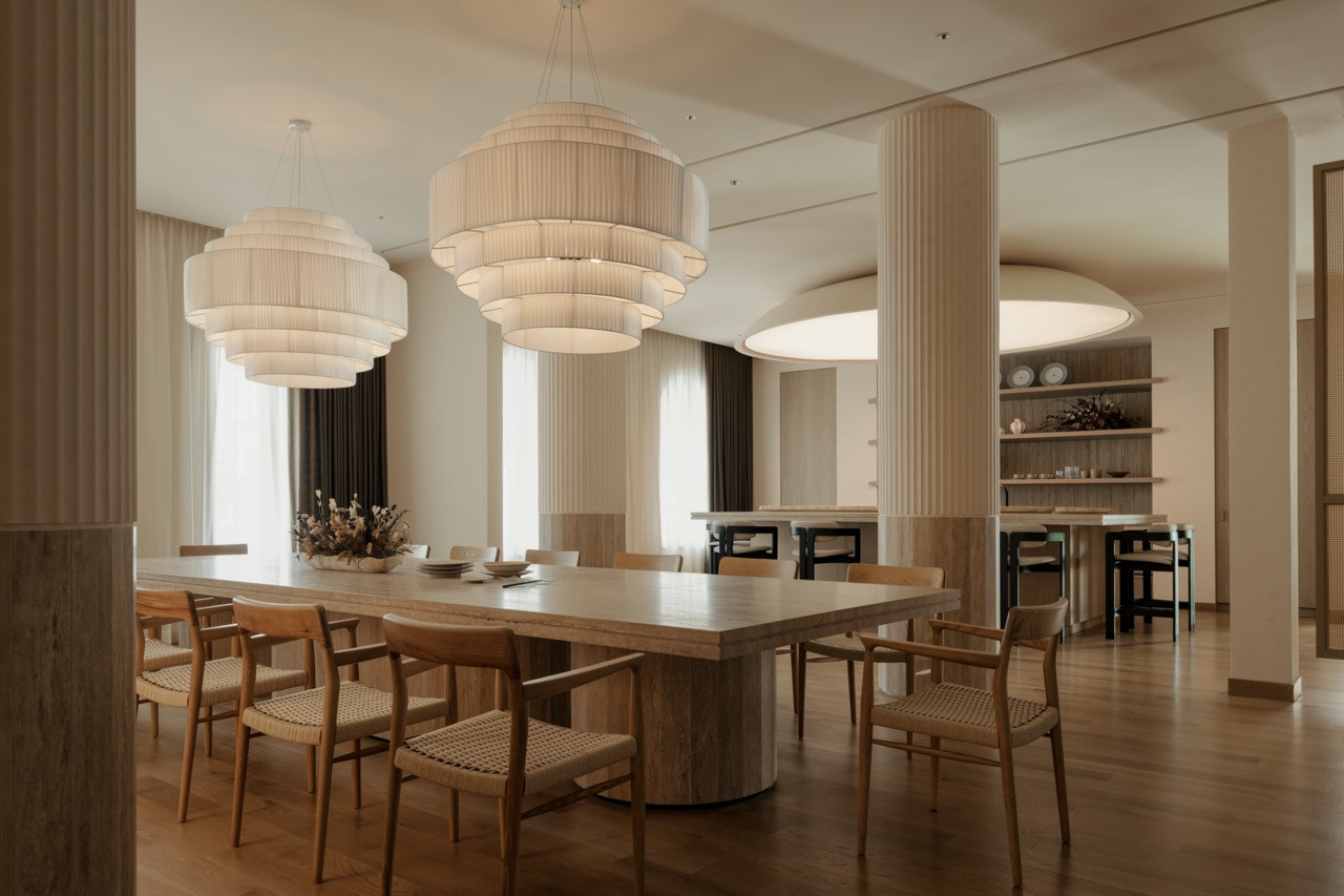 The dining area with multiple custom pendant lights from Big Brain and fluted columns, which Lim considers one of his favourite parts of the completed Mediterranean-inspired clubhouse