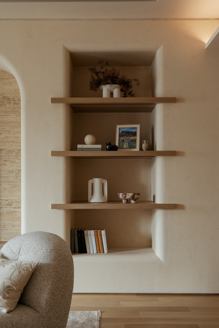 Built-in timber shelving with controlled lighting, part of what Lim describes as the project’s ‘restrained material backdrop that allows artworks to stand quietly on their own’