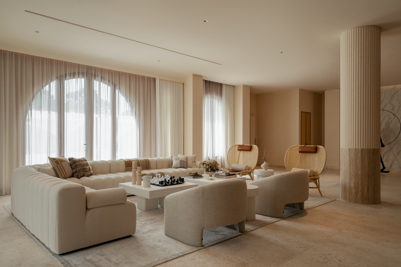Living area with Norr 11 Studio Sofa and arched windows that allow natural daylight throughout, part of the passive sustainability strategy