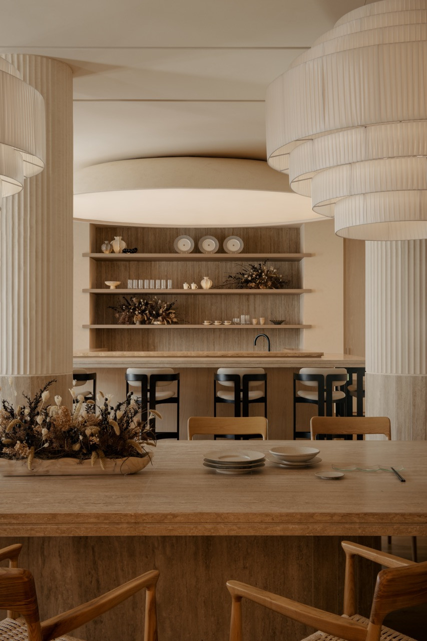 View of the omakase bar with custom pendant lights from Big Brain and ash-wood braided-roped dining chairs from Forest Furniture