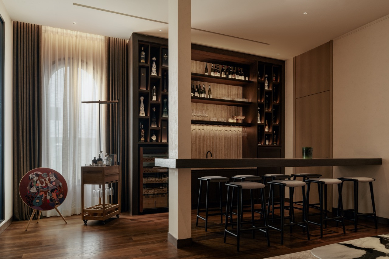 The bar area with cigar storage and timber shelving, adjacent to the private omakase bar