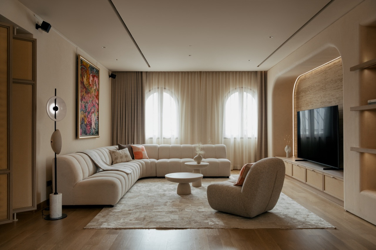 The living room is anchored by a Roche Bobois Mah Jong sofa in Jean Paul Gaultier couture fabric, with a Bolia Mielo armchair and a King Living Jasper coffee table in travertine