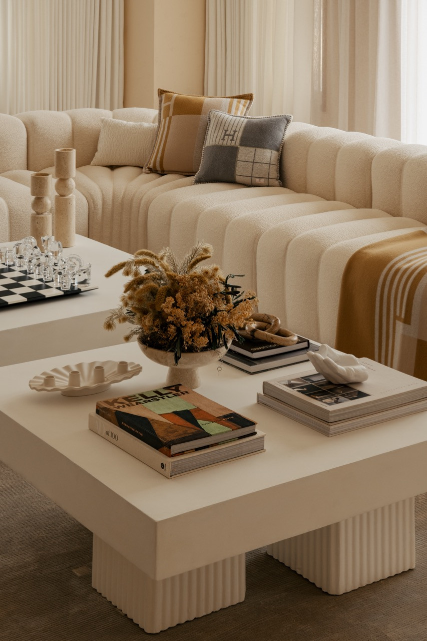 Coffee table detail with display books from Kinokuniya, St Louis Clear Crystal Levitating Prestige Chess Set, and Audo Copenhagen’s Interconnect candle holder