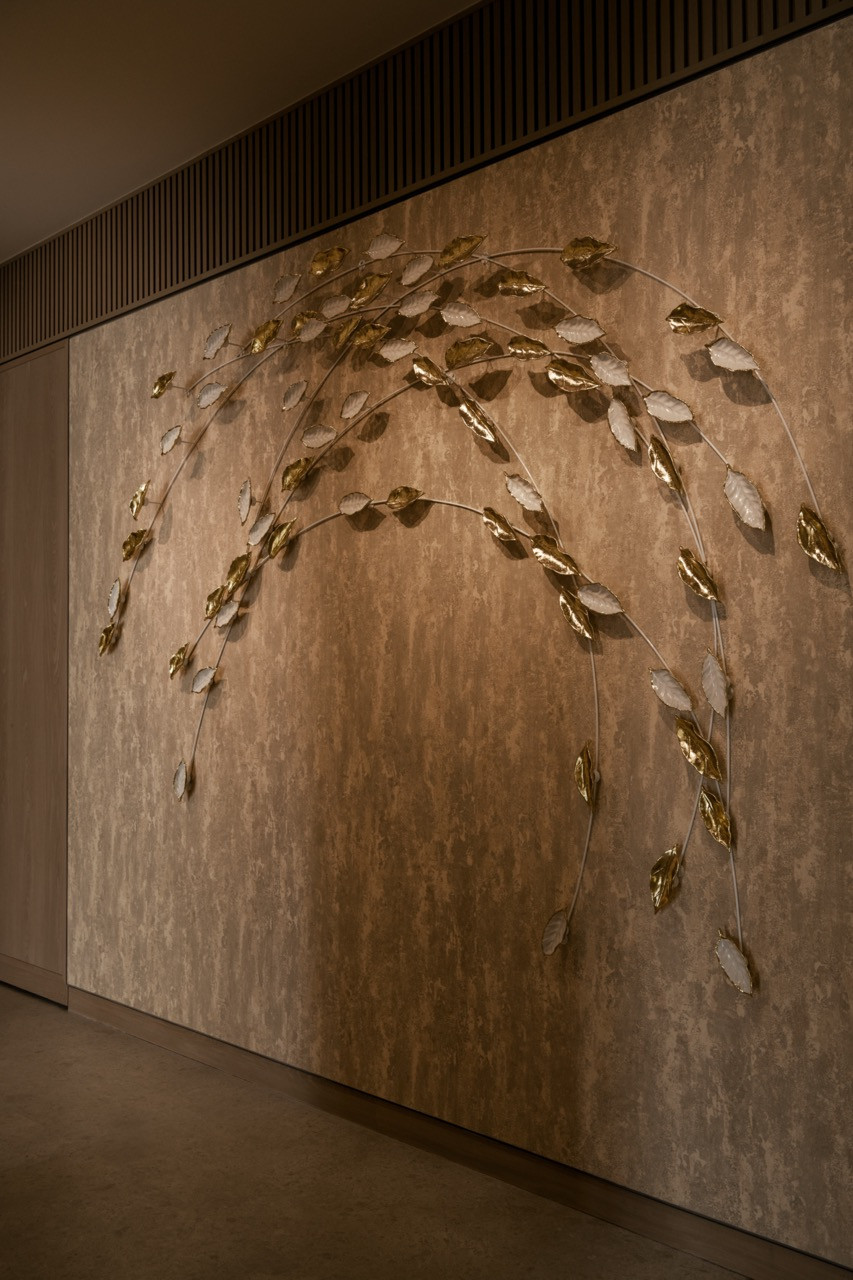 James Seet’s ceramic leaf installation mounted on textured plaster wall, part of the site-specific artwork created for the clubhouse