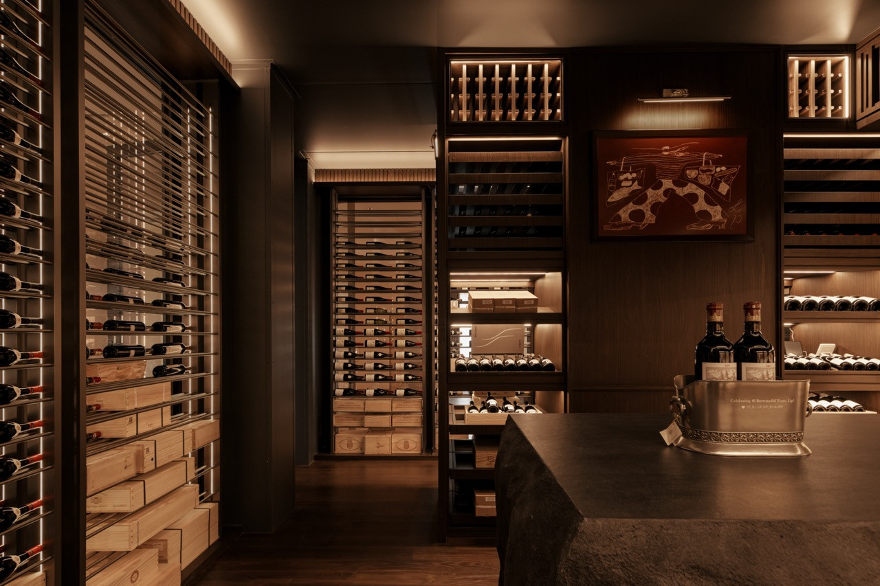 The wine cellar with a stone counter and controlled lighting is one of the spaces that transformed the property into an ‘entertainment-focused private clubhouse.'
