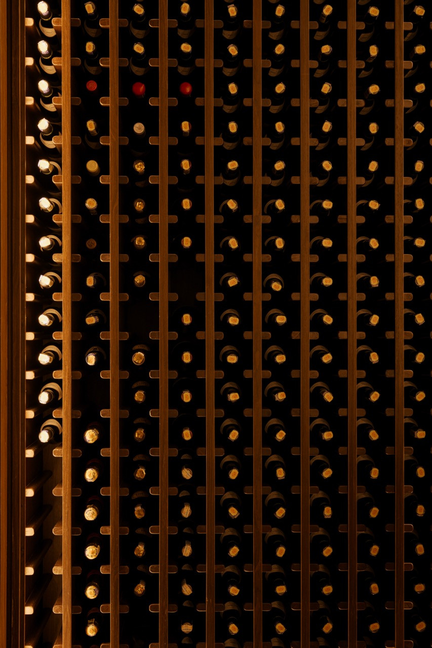 Wine cellar detail with timber racking, part of the clubhouse's specialised entertainment spaces