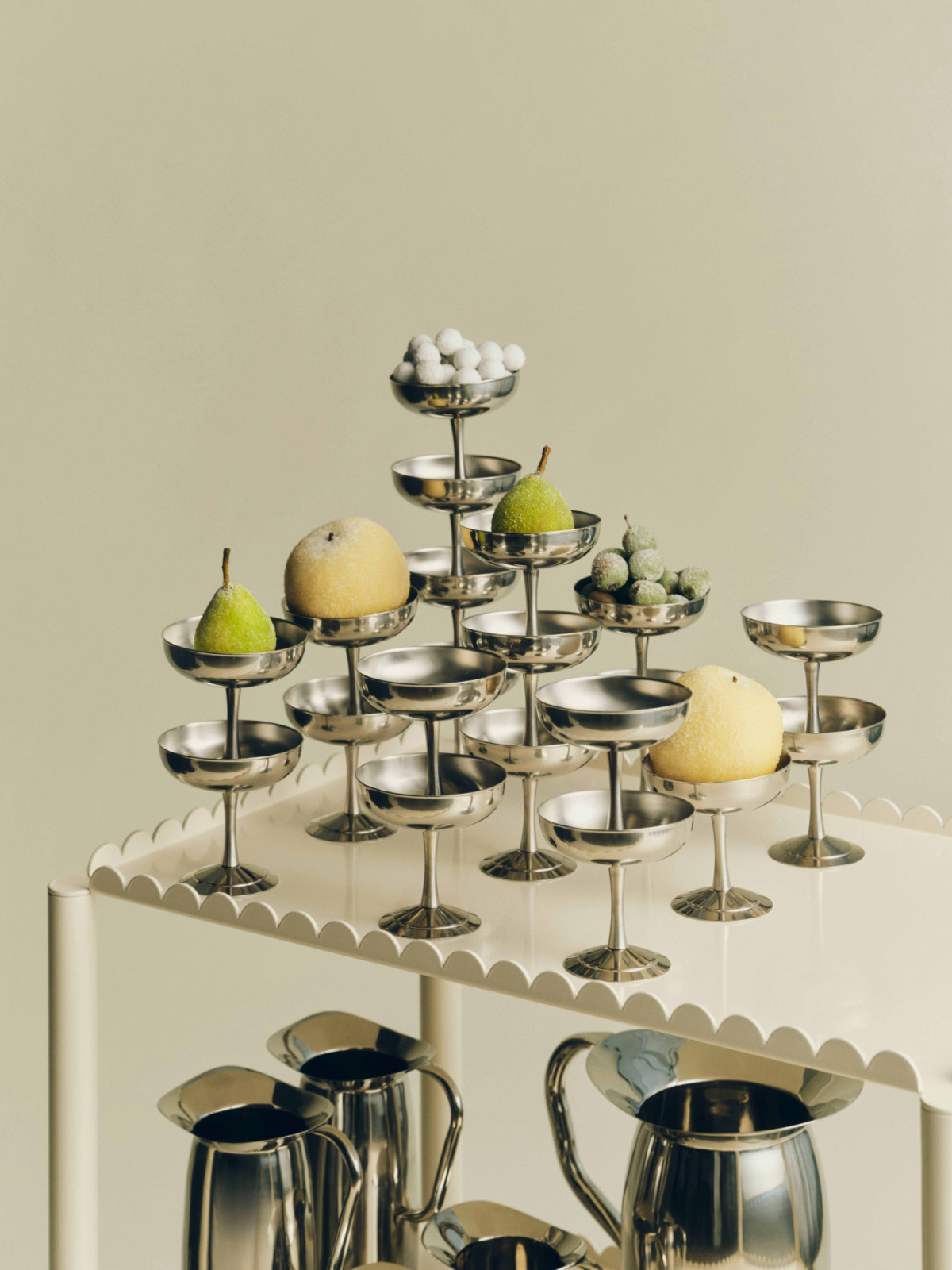 A playful trio of products from Hay—the Arcs Trolley High in eggshell, Indian Steel Pitcher and Italian Ice Cup 01—adds function and ease to festive entertaining