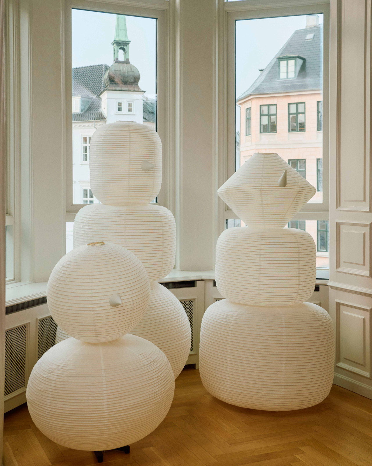 The Hay Paper Shade family 02 features paper lanterns shaped like snowmen, bringing a light-hearted glow to festive interiors