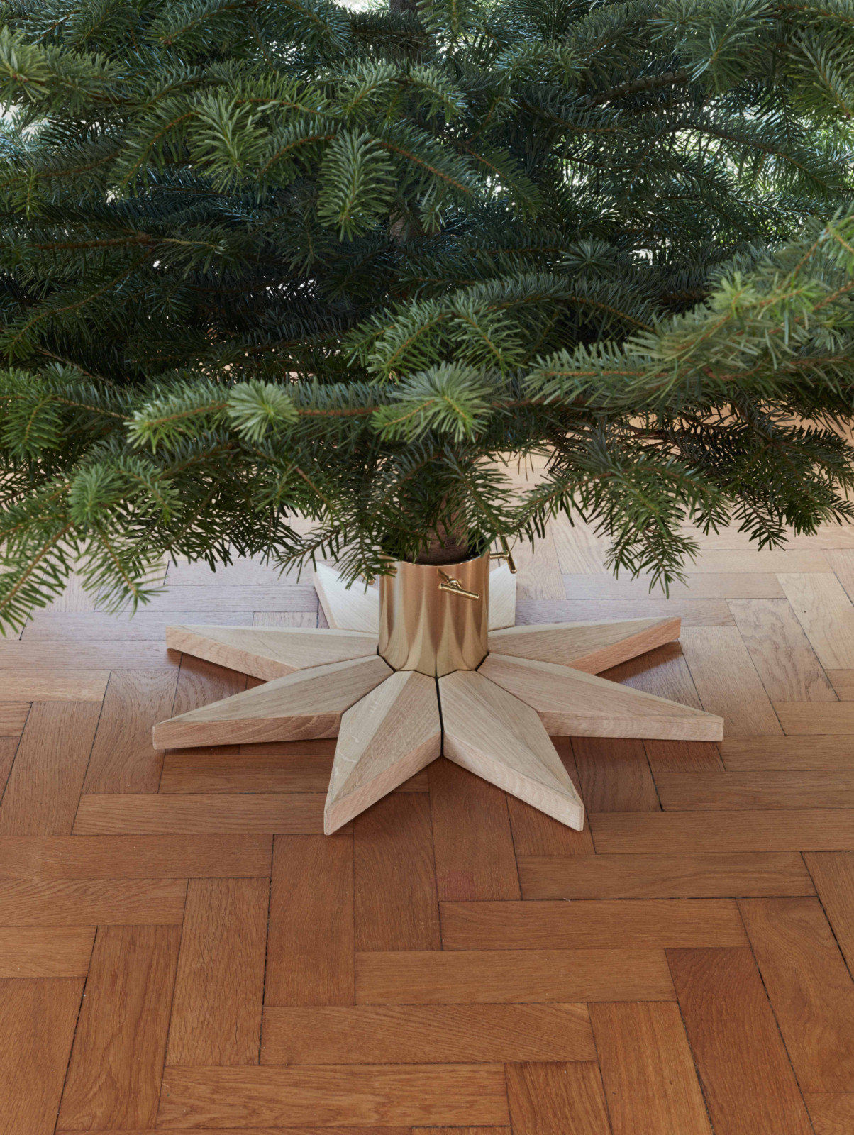 The Skagerak Stella Christmas tree base by Fritz Hansen anchors the tree in solid, decorate base, bringing elegance to festive decor