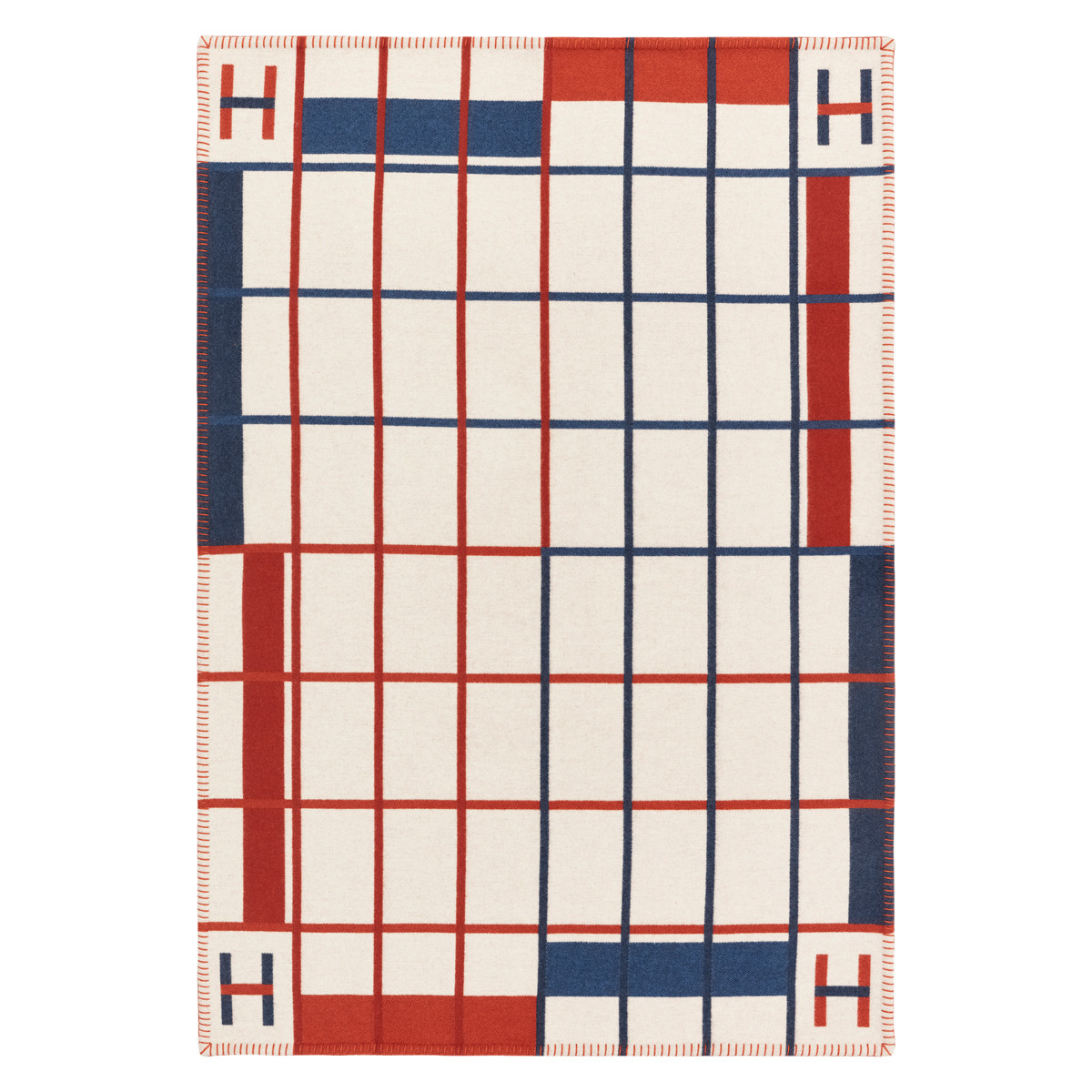 The Hermès Avalon Clairière square plaid in jacquard-woven Merino wool showcases graphic lines and the maison’s signature H motif