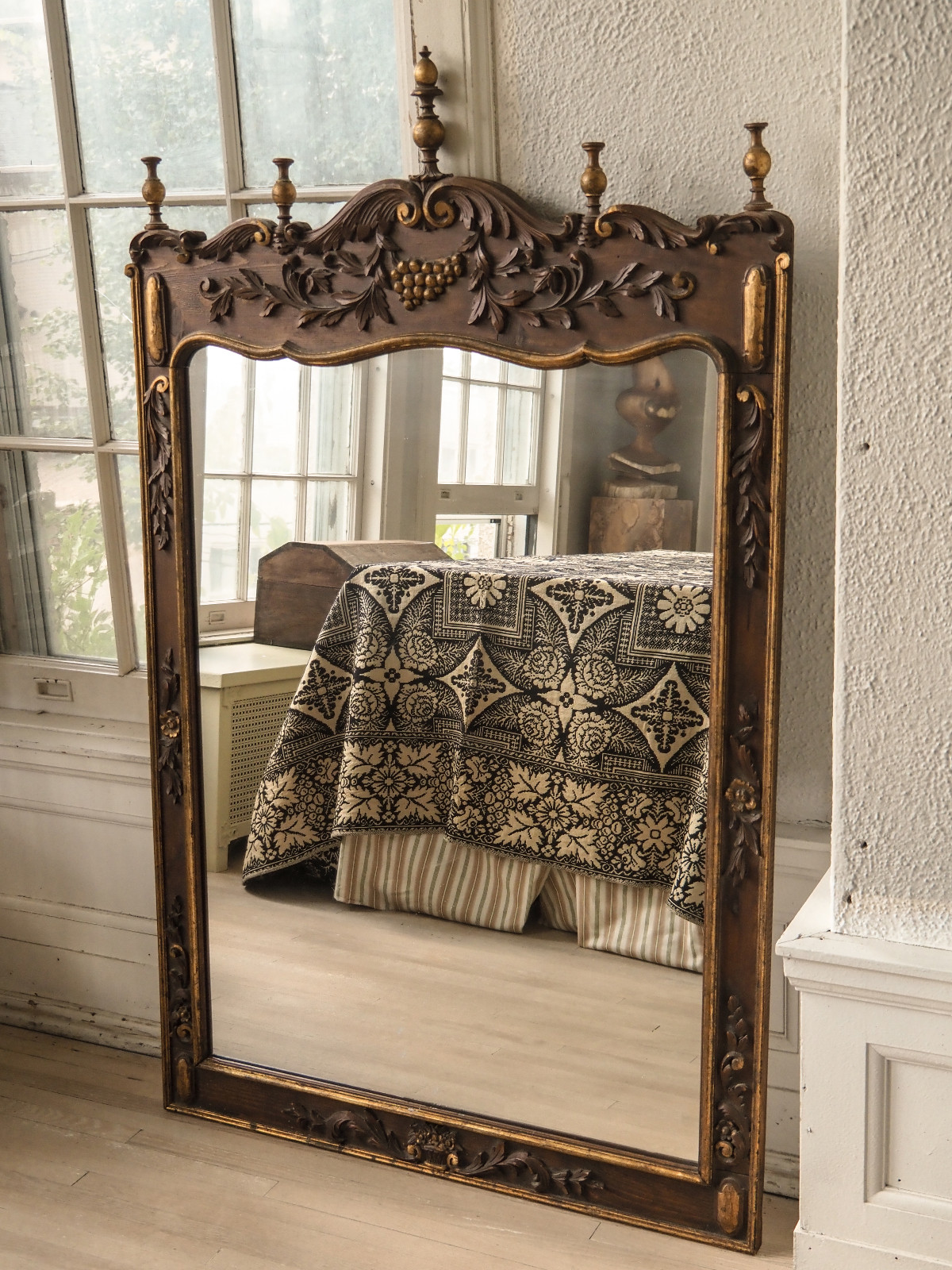 A vintage mirror sourced from Maison Bodega, designed to add timelessness to any gathering space