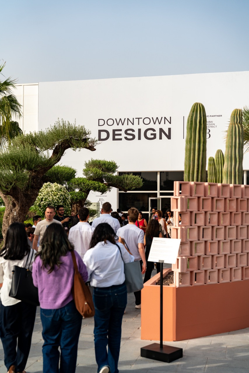 Downtown Design entrance at Dubai Design District during Dubai Design Week 2025, with modular terracotta block installation and cacti planters greeting visitors arriving at the twelfth edition of the fair
