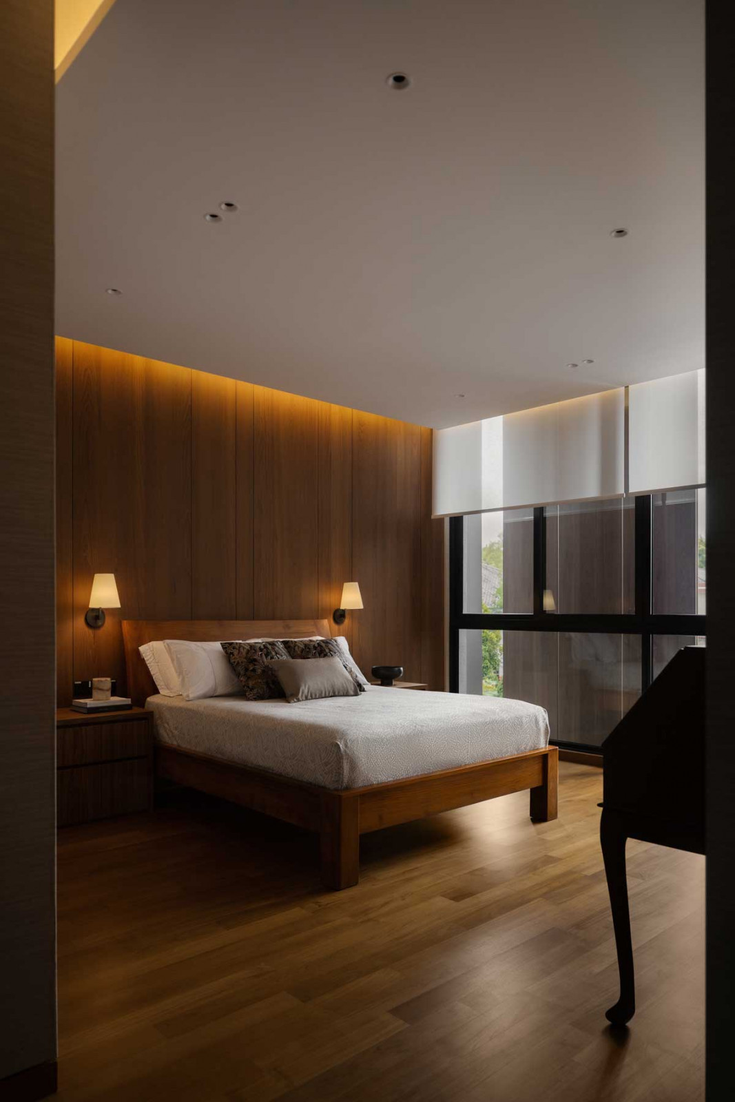 The master bedroom is cloaked in stylish grey and brown shades
