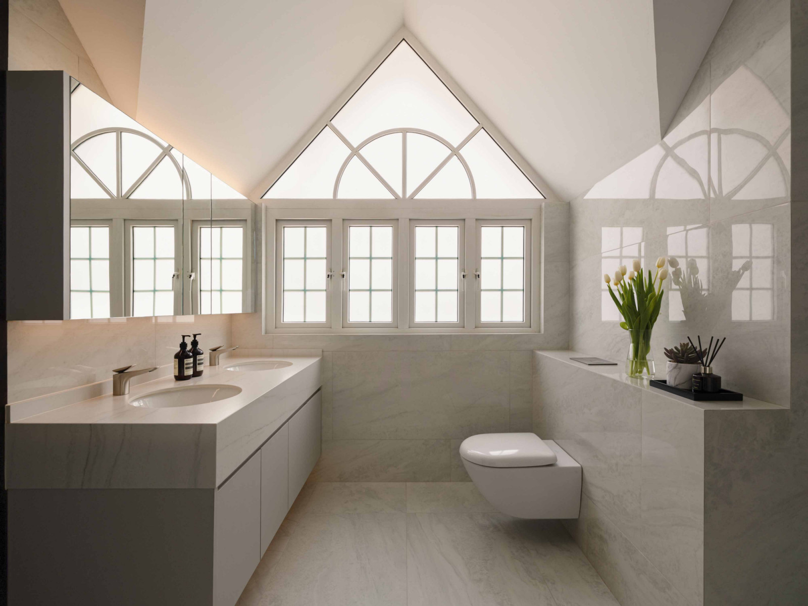 Gable windows add architectural charm to the Bukit Timah bungalow’s attic bathroom