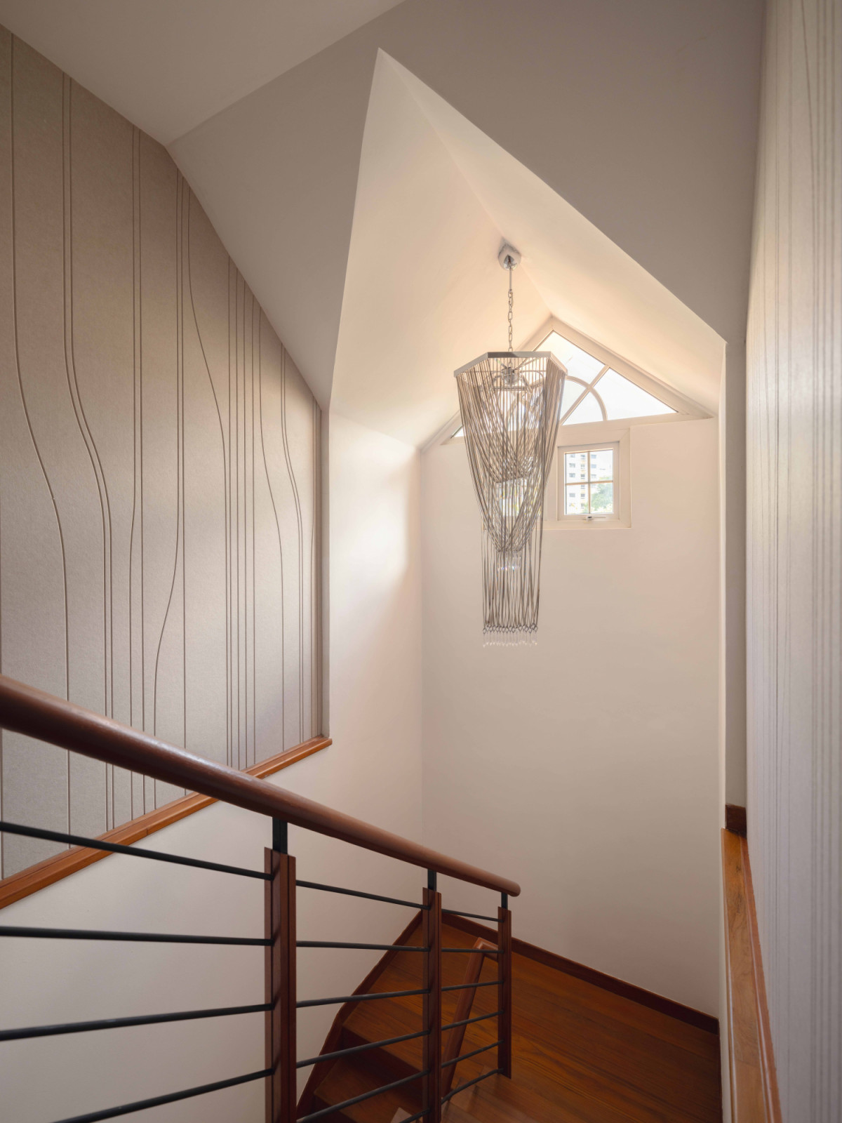 The majestic Lamia chandelier presides over this stairwell