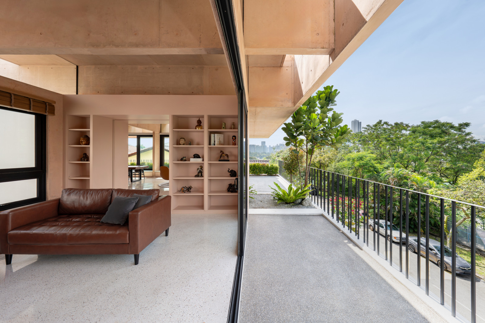 The pink concrete structure sits atop the combined terrace houses like a distinct volume