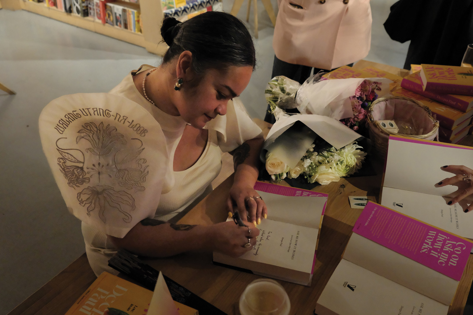 Deepa Paul signs copies of ‘Ask Me How It Works’ during her book launch in London, United Kingdom (Photo: Dandy Ng)