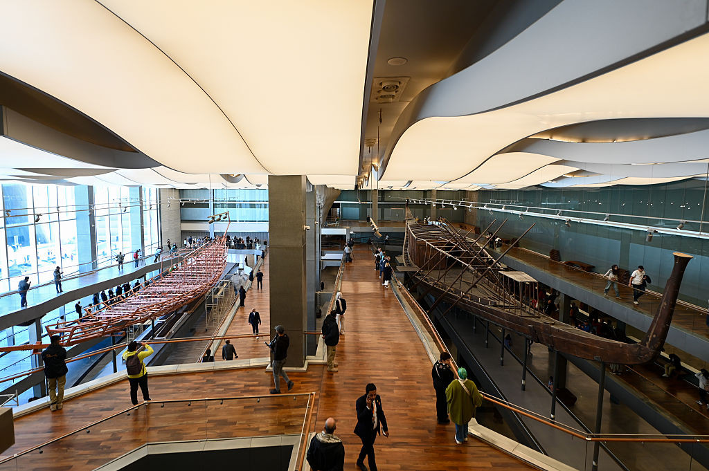 CAIRO, EGYPT - DECEMBER 23: Workers move the Khufu boat planks to a designated display location in the Grand Egyptian Museum as pieces from the second of two Khufu boats, solar barques that were buried alongside the pharaoh Khufu in 2500 BC, at the Grand Egyptian Museum on December 23, 2025 in Cairo, Egypt. The two Khufu ships were discovered in a sealed pit at the Great Pyramid in the 1950s. The first was reconstructed and went on display in the 1980s; the other was in a more dilapidated state and its rest