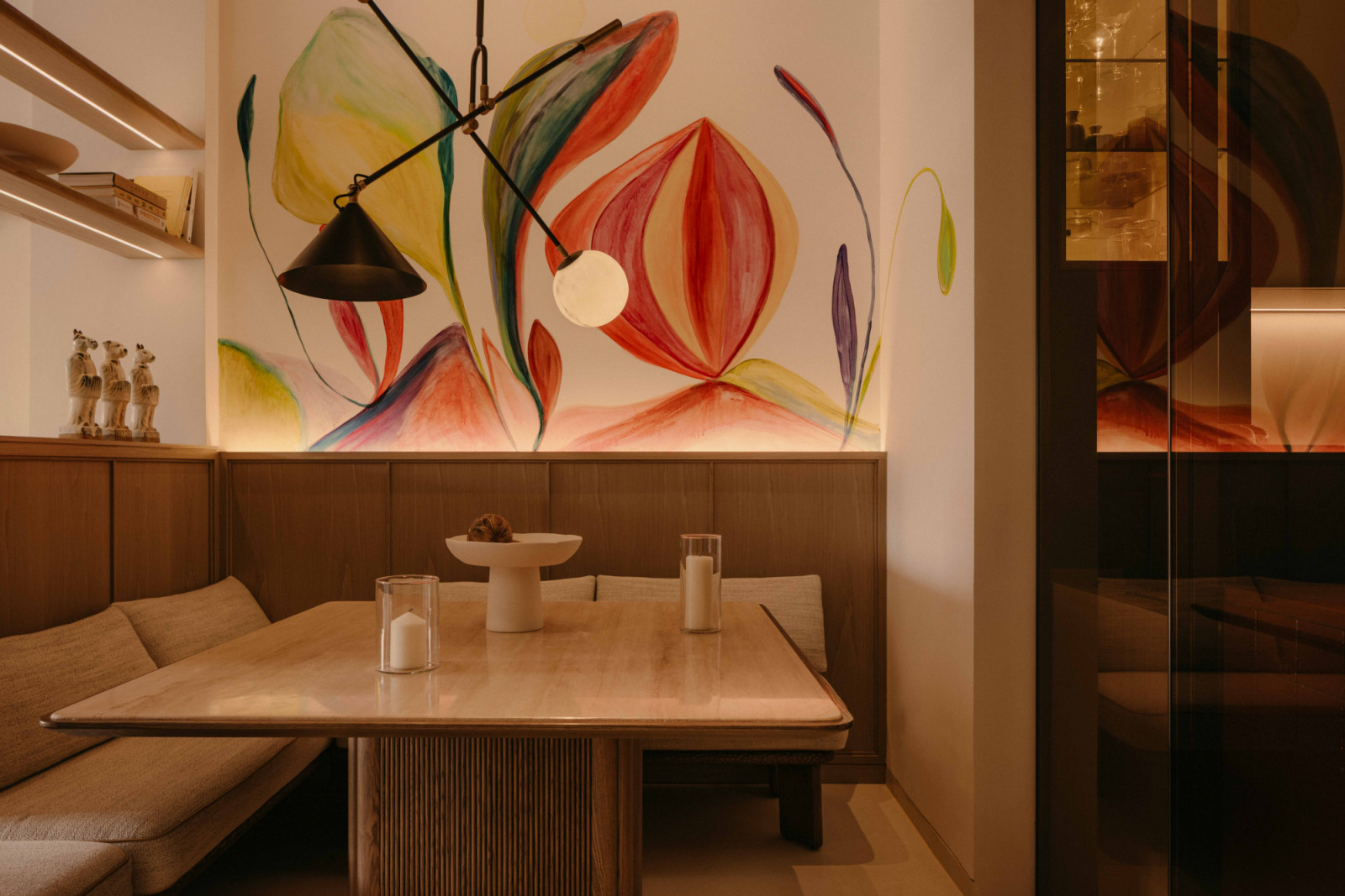 This intimate dining corner features restaurant-like banquette seating with sliding door to the kitchen’s coffee corner