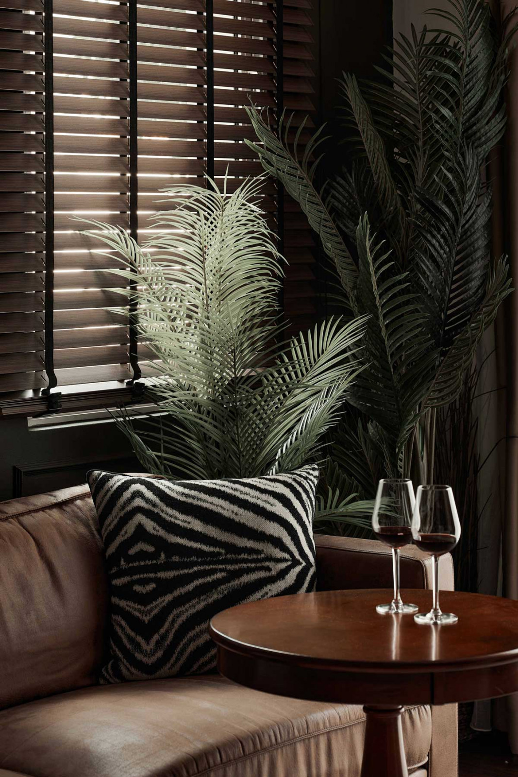 The plants and zebra-print throw pillow echo the safari themes permeating the home