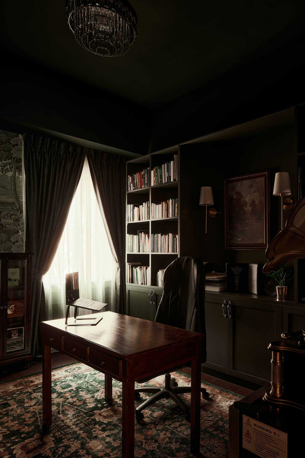 The handsome study is a moody room replete with timber panelling and vintage-style fixtures
