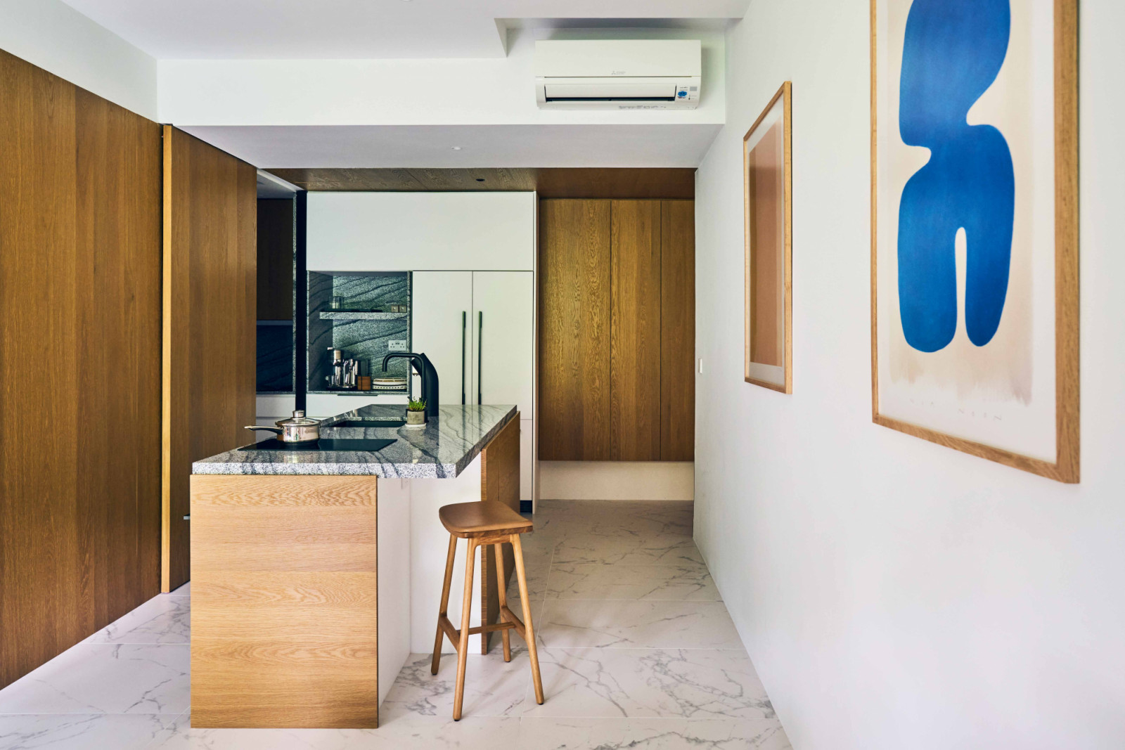 The pale wood cladding reflects light and brings mid-century modern character and texture to the interior