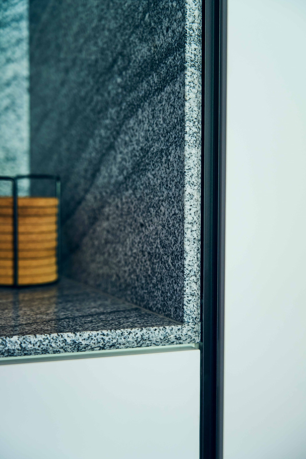 The meeting of timber and stone at the kitchen counter reflects the home’s mid-century modern influence