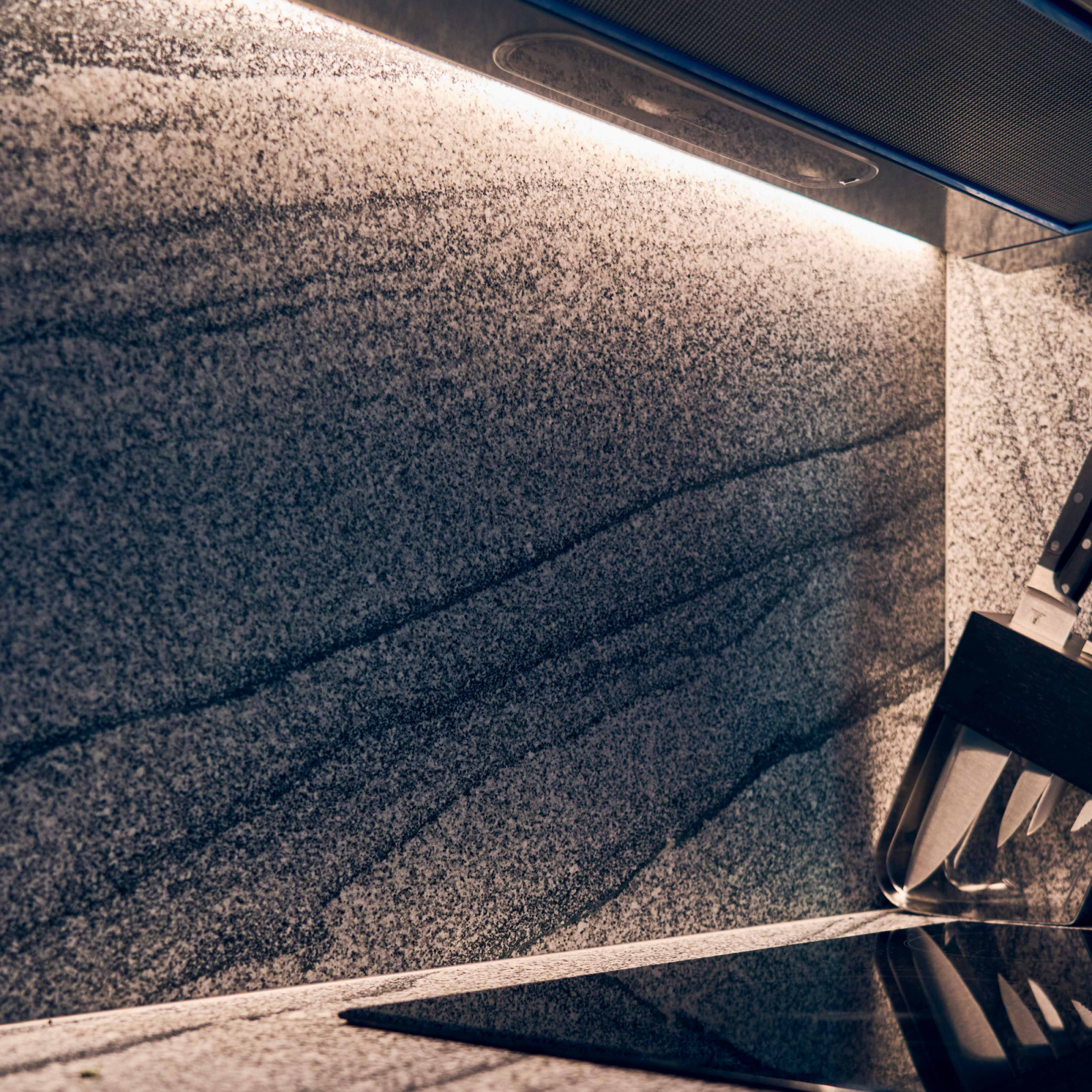 A close-up of the speckles and prominent veining on the stone backsplash