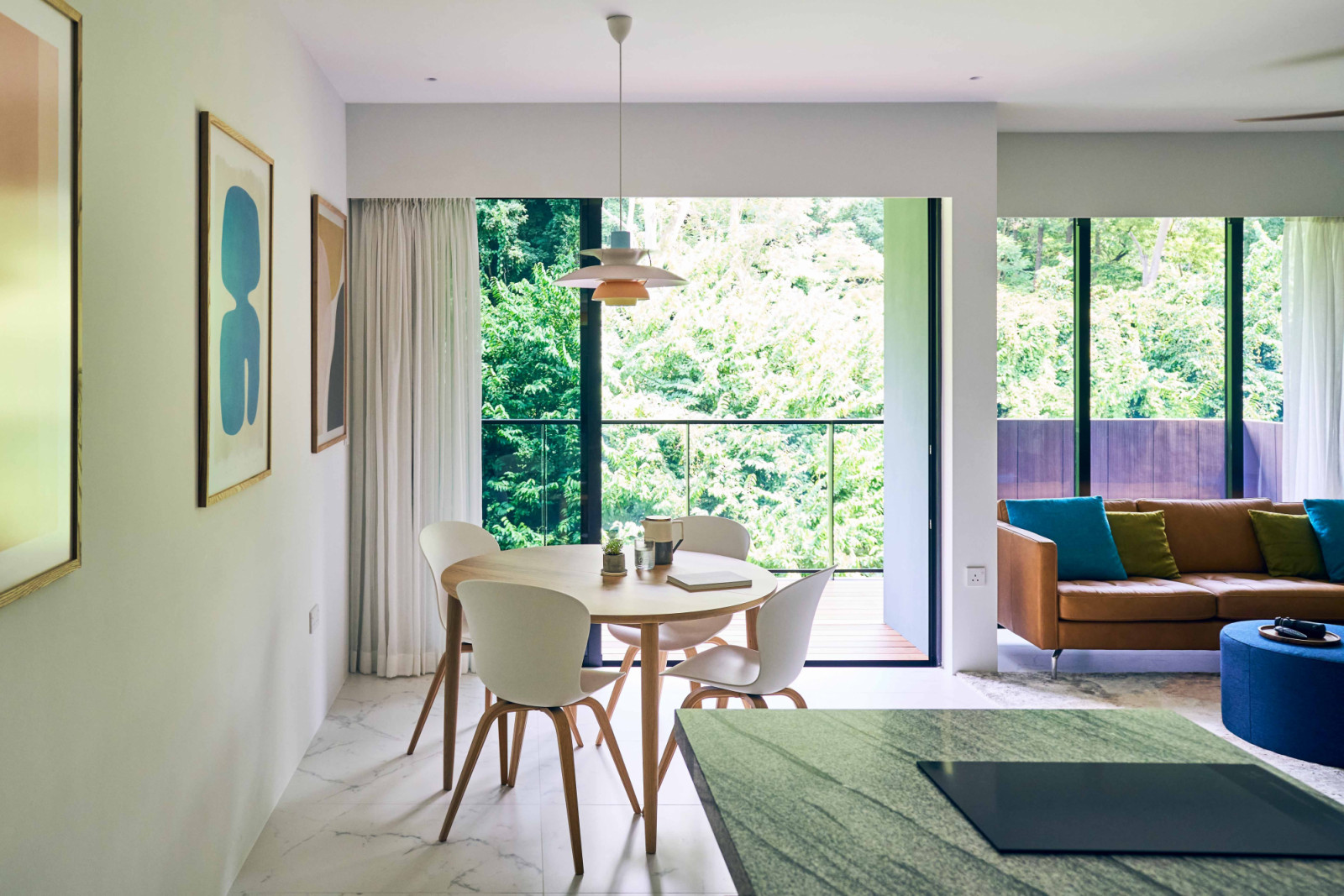 The dining room, lit by a mid-century modern icon Louis Poulsen pendant, looks out towards the greenery beyond Kent Ridge