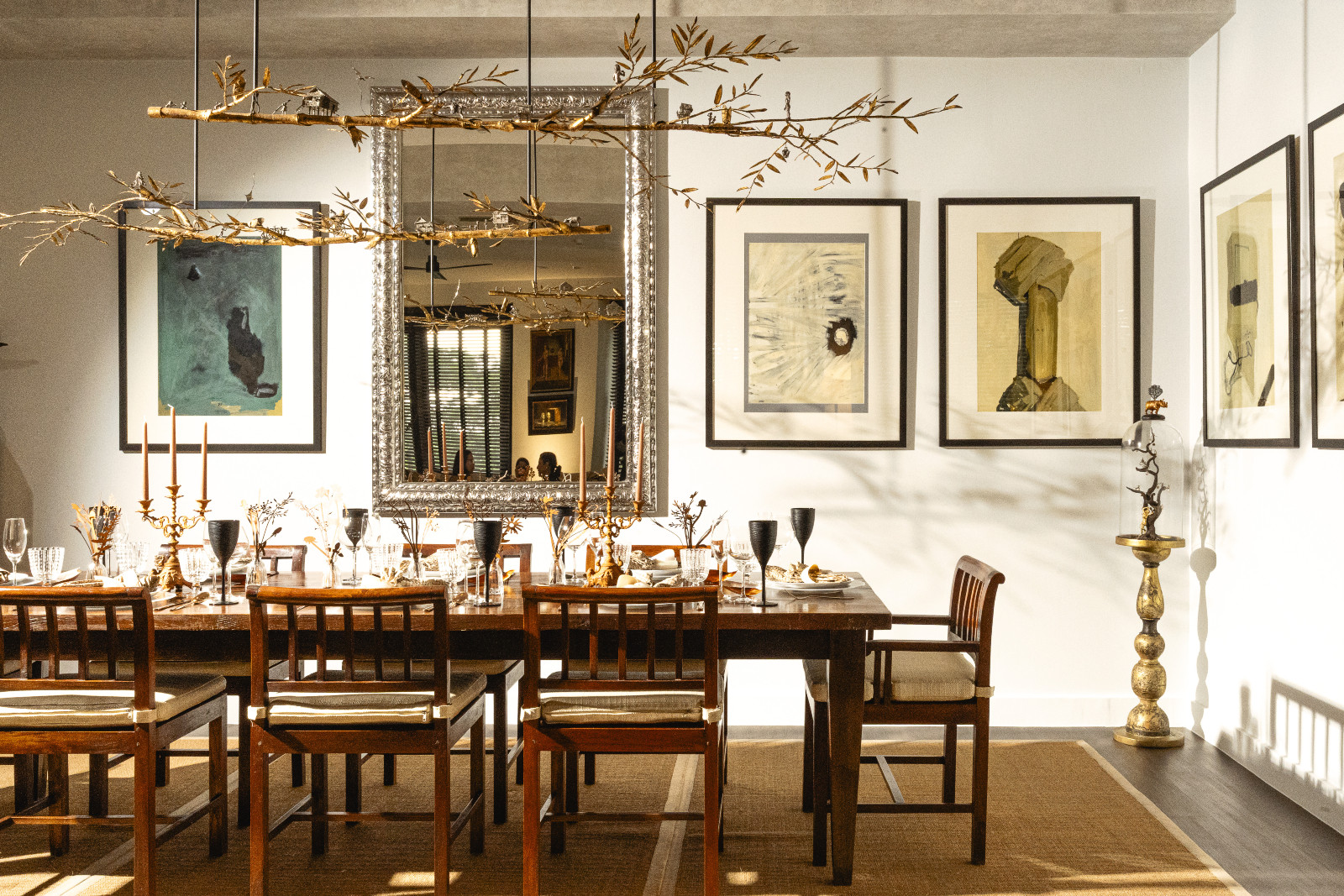 Dramatic and restrained dining setting, hovering above is a light fixture designed by Wynn Wynn Ong inspired by local Filipino “Malakas and Maganda” lore