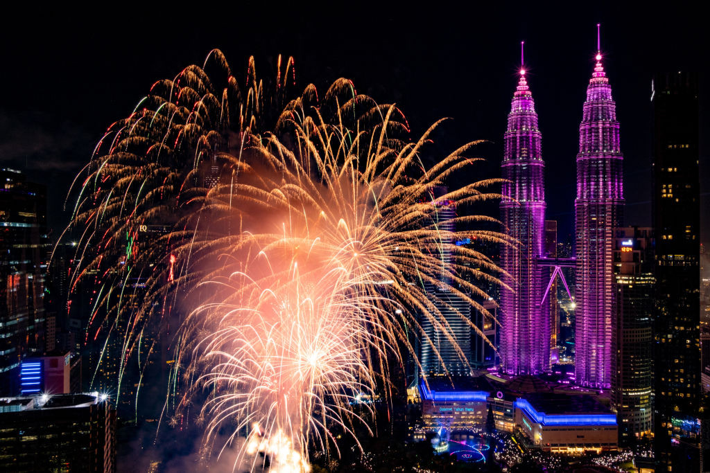 KUALA LUMPUR, MALAYSIA - JANUARY 1: A view of the 2025 New Year's Eve celebration with colorful bursts display of fireworks over the iconic Petronas Twin Towers and KL Tower from the Felda Tower observation deck as it marked the start of 2025 in Kuala Lumpur, Malaysia on January 1, 2025. (Photo by Syaiful Redzuan/Anadolu via Getty Images)