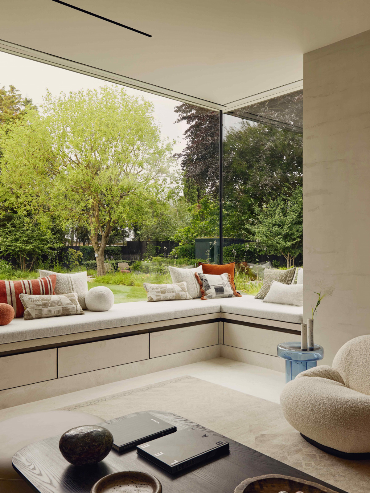 Custom marble window seat with upholstered cushions by De Le Cuona