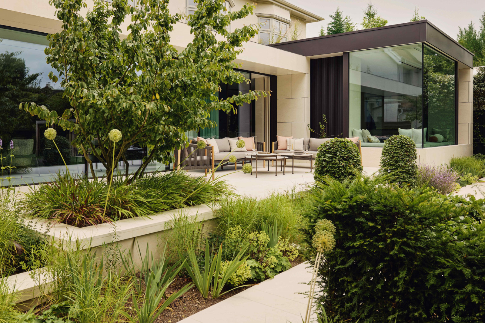 The outdoor seating area amidst the greenery in the rear garden
