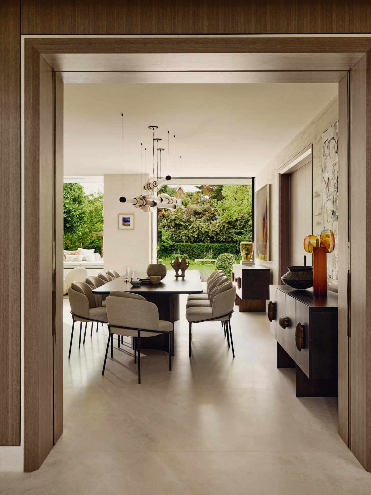 The dining area features a statement pendant by Gabriel Scott