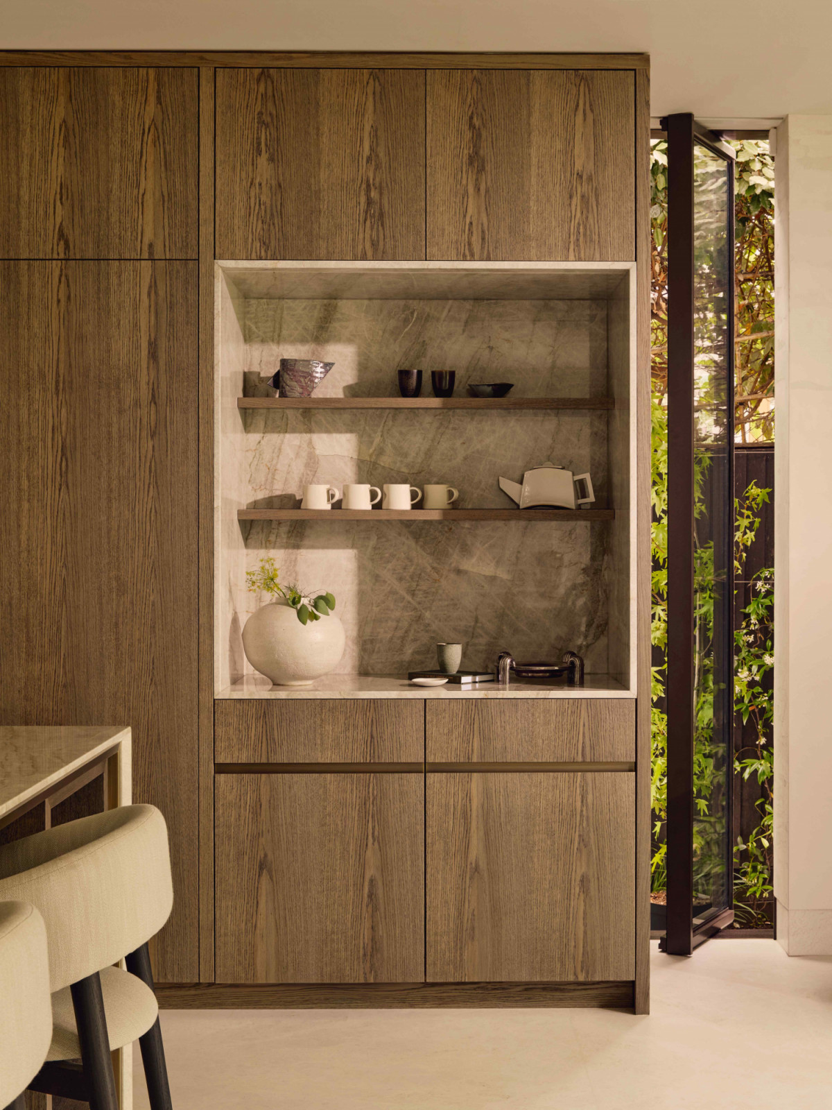 The stained oak cabinetry designed in collaboration with Lanserring