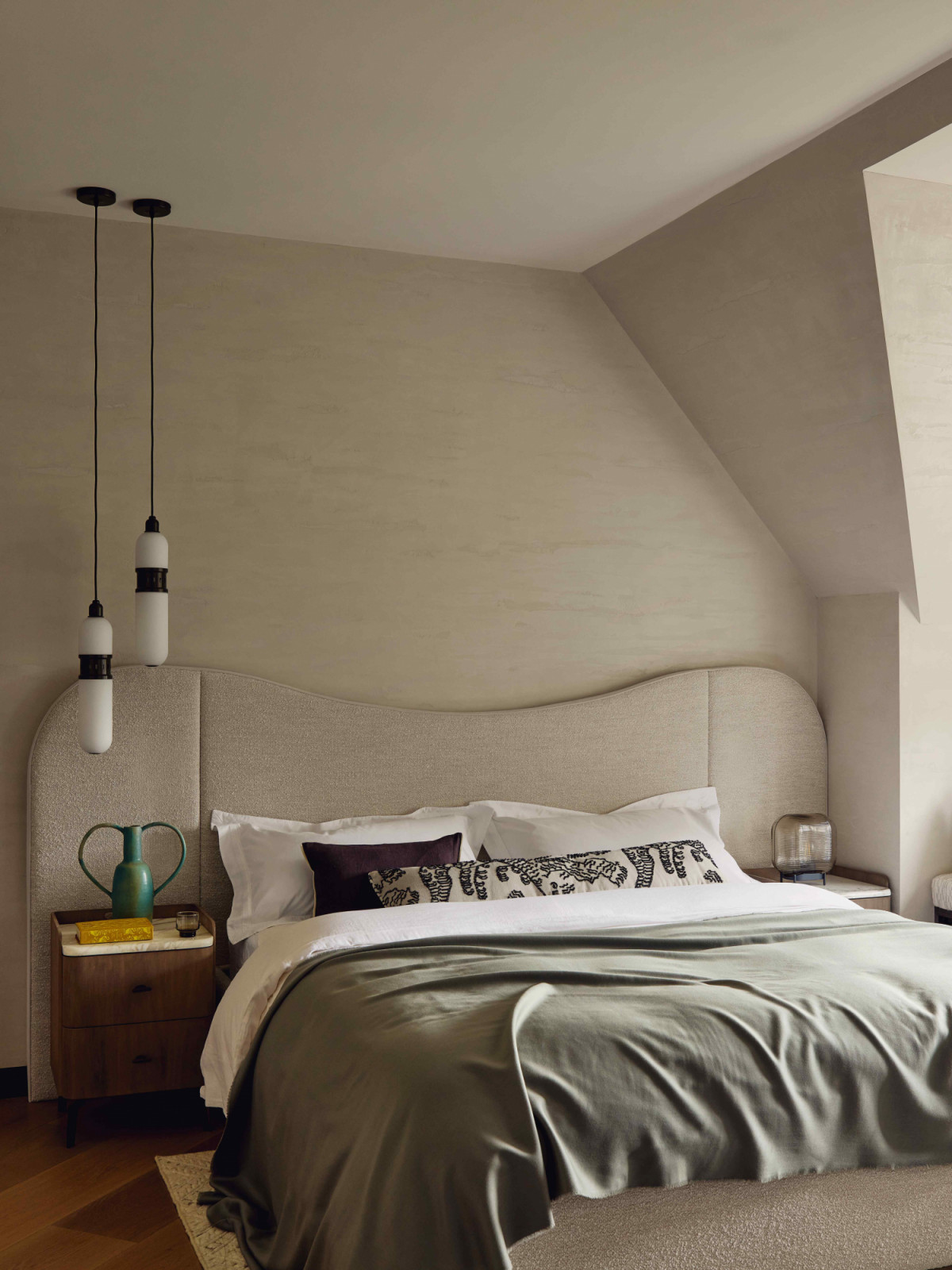 The children’s bedroom features a custom sculptural headboard and Occulo pendants by Bert Frank